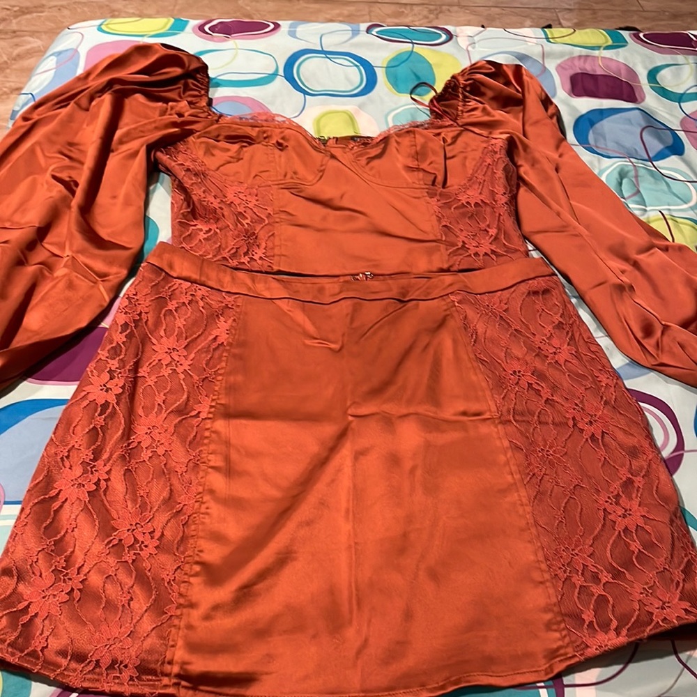 A copper color two piece set skirt and crop, looks like a dress when wearing.
